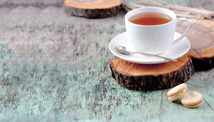 A cup of hot herbal tea and cookies on the old wooden background. Cup of tea herbal tea hot drink Baking Cookies Vintage texture background