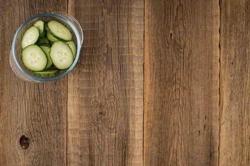 cucumber slices on wooden background.