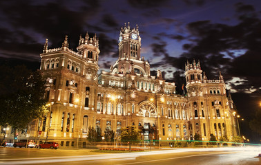 Fototapeta na wymiar Cybele Palace at the Plaza de Cibeles with light trails of the traffic night, Madrid, Spain