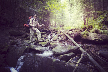 Man tourist walking the mountains with a backpack.
