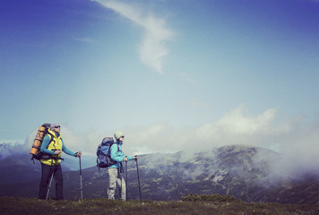 Man tourist walking the mountains with a backpack.