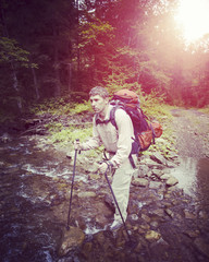 Man tourist walking the mountains with a backpack.