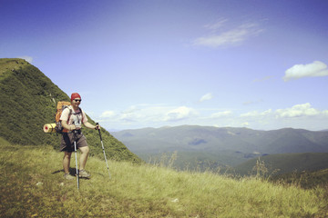Fototapeta na wymiar Man tourist walking the mountains with a backpack.