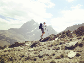 Man tourist walking the mountains with a backpack.