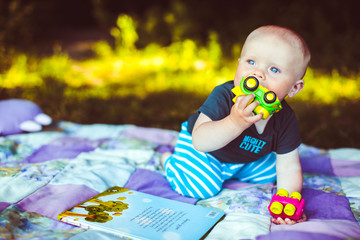 The small boy playing with toys in the park