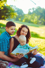 The mother,father and  son reading a book