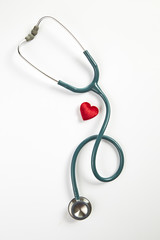 Red heart and stethoscope isolated on white background