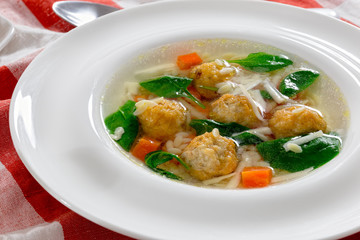 delicious wedding soup with meatball, carrots and spinach