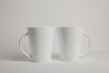 two white mugs on white background