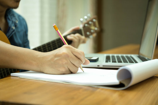Selected focus on pencil songwriter working on new composition
