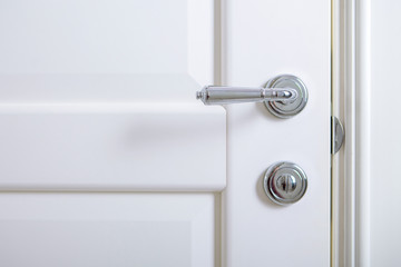  classic chrome door knob on white door