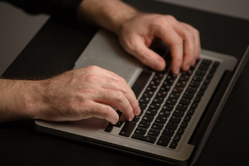 male hands typing on the keyboard