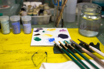 Selected focus paintbrushes and blue color on palette with paint