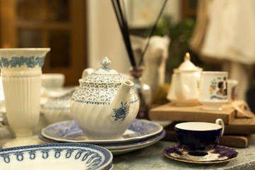 Blue and white set of old and dusty teapot and cup