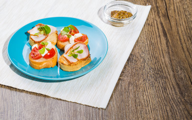 Bruschetta with tomato, cheese and bacon