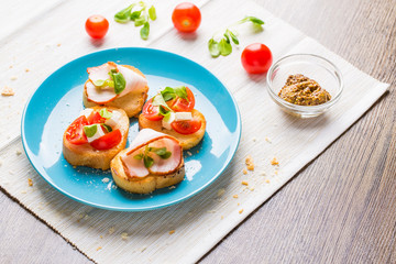 Bruschetta with tomato, cheese and bacon