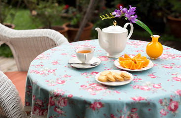 Selected focus tea cup English tea with orange fruit and biscuit