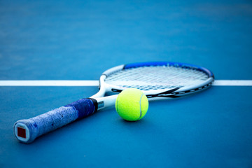 Tennis ball and racket on tennis court