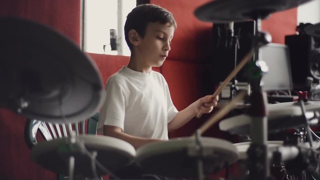 little boy playing electronic drums