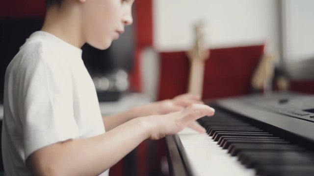 little boy playing the piano