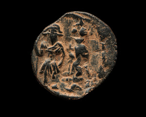 Ancient copper Byzantine coin isolated on black