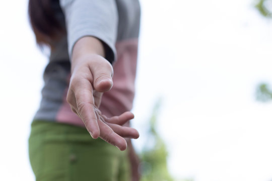 Help concept woman hand reaching to pick up someone