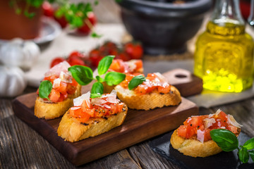 Tasty bruschetta with tomato,  basil, parmesan, olive oil ...