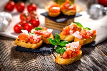Tasty bruschetta with tomato,  basil, parmesan, olive oil ...