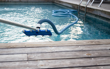 cleaning swimming pool with vacuum tube cleaner