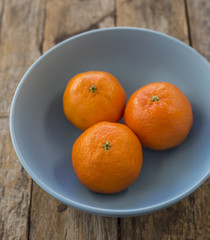 Ripe mandarine citrus . tangerine mandarine orange on wooden background. Mandarins in plate