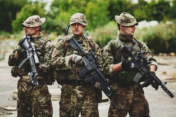 Soldiers on patrol in destroyed city. Military and rescue operation