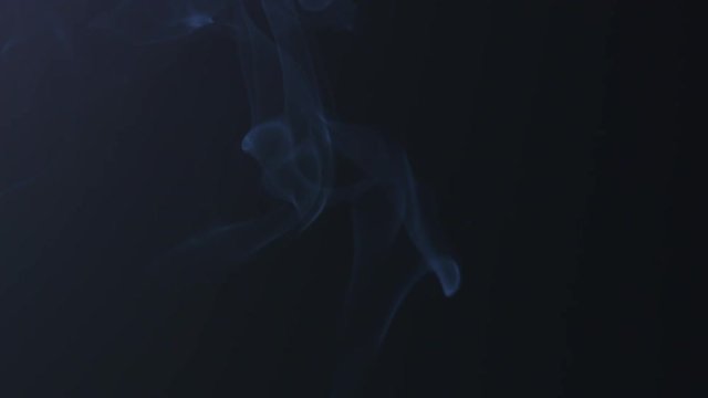 blue mystery smoke rising over black background, slowmo footage 180fps prores