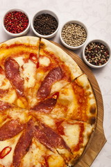 Pizza with at and set different peppers