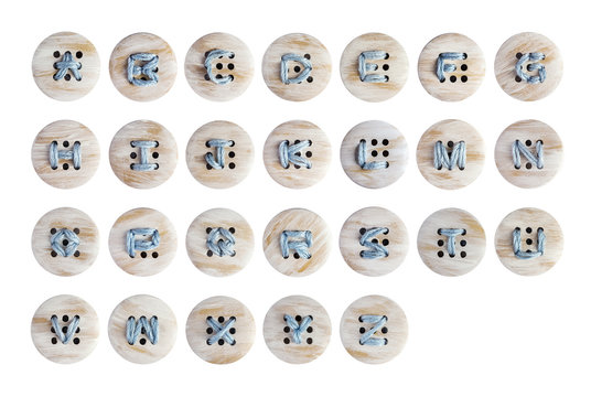 English alphabet of embroidery on wooden botton