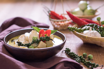Chicken mussaman curry in bowl vegetables on wooden background