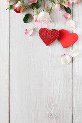 Fototapeta premium Valentine day background, hearts and flowers on white wood