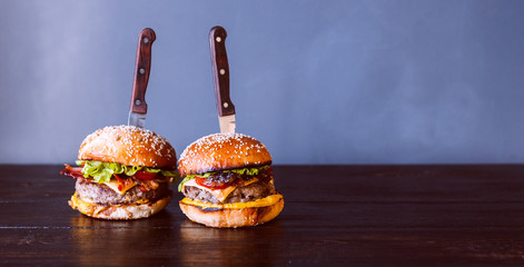 tasty and delicious juicy burger with beef and bacon on a grill