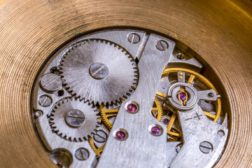 Macro cog clockwork mechanism close up micro workings of watch with metallic wheel timepiece precise motion & rotation
