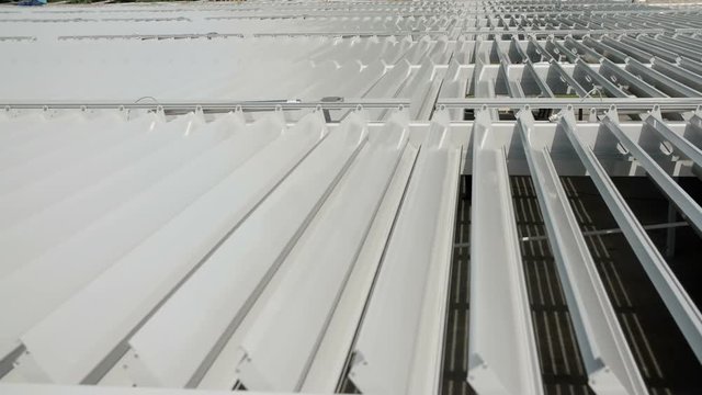 Sun protection roof is now open and the daylight comes into a parking lot. Close-up shot.
