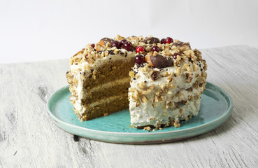 Carrot cake with cream cheese, nuts, berries and tangerines
