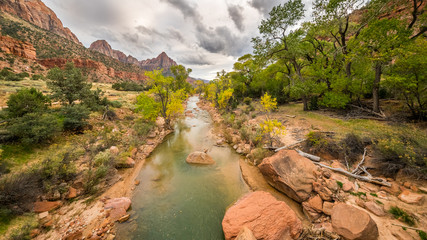 Large stones among water flow. The Virgin River flowing through Zion National Park, Utah, USA