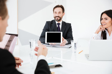 Business man showing blank tablet computer screen