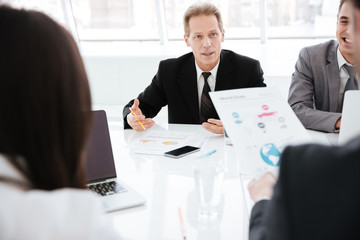 Group of business people by the table in office