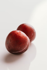 plum fruit whole on a light background closeup