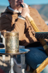 man smoking shisha outdoor