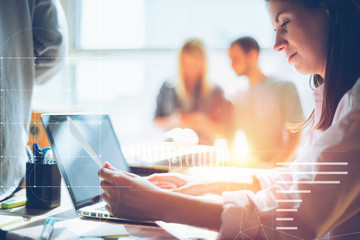 Woman researching new project. Teamwork in open space office. Paperwork on the table, laptop and...