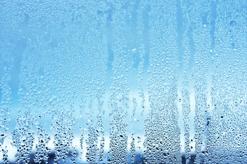 Window glass in the condensate in the cold currents of the water drops background - obrazy, fototapety, plakaty