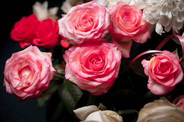 Still life of rose bouquet flower. Beautiful fresh pink roses. Rose Posy Wedding Bouquet. heap of pink and white fresh roses. Street flower market. Different roses on a black background