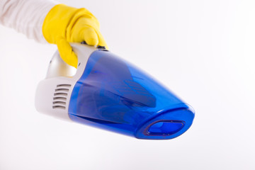 Maid holding vacuum cleaner on white