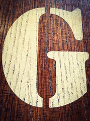 Wooden alphabet letter G. Written letter with paint on a wooden background. Alphabet wood texture. 